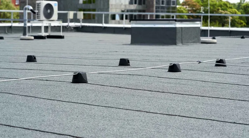 Commercial flat roof with rooftop HVAC equipment and membrane seams